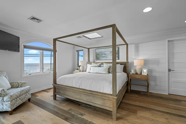 a bedroom with a bed couch and window