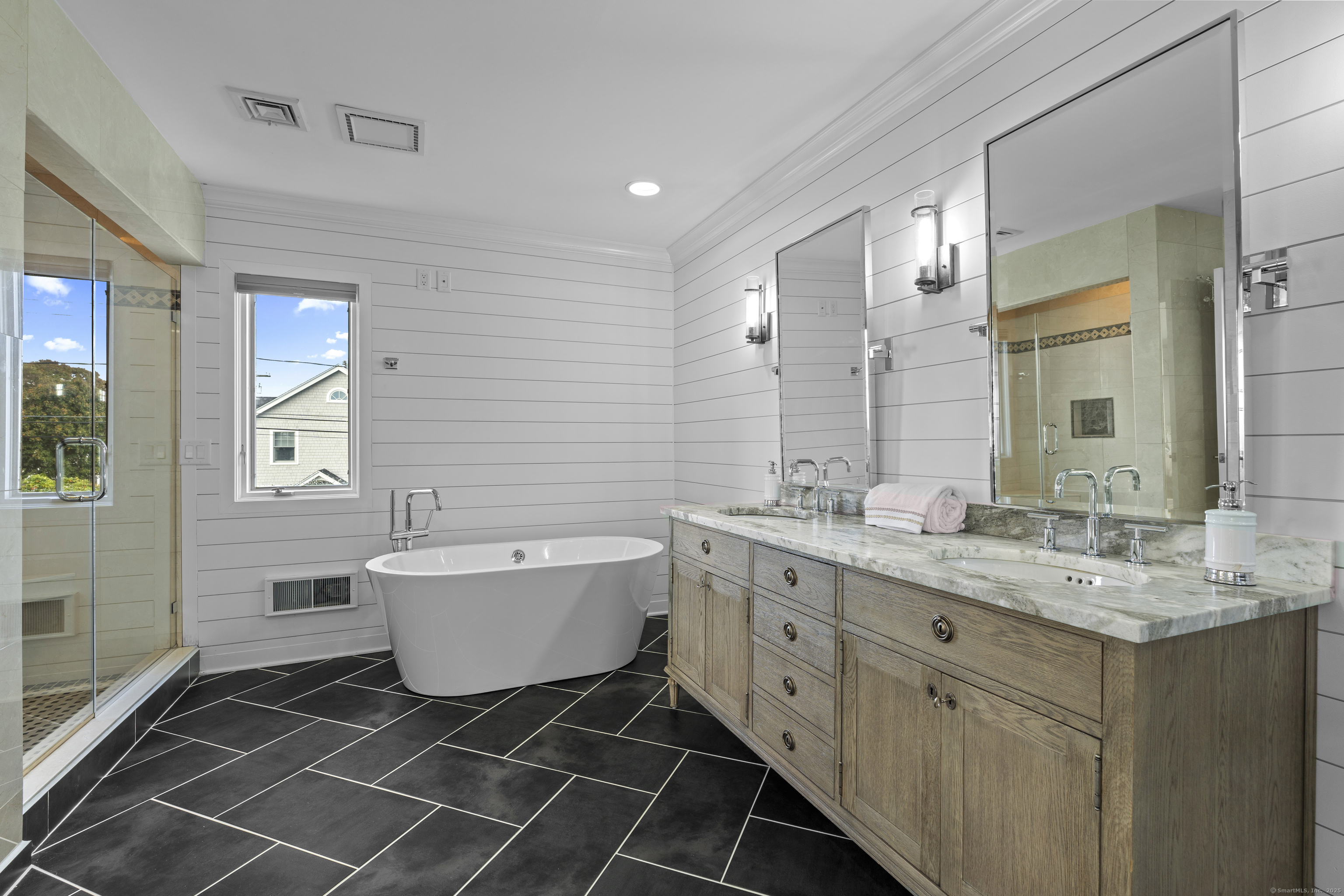 372 Maple Avenue Old Saybrook, CT 06475 - Photo 27 of 40 a bathroom with a double vanity sink a mirror and a bathtub