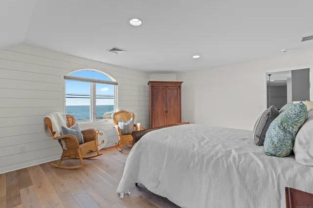 a bedroom with a bed a table and chair