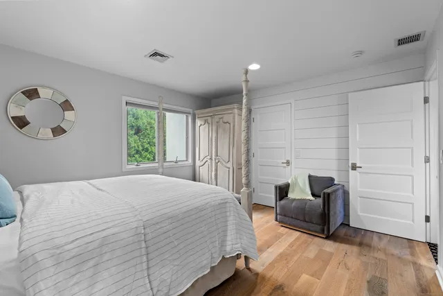 a bedroom with a bed and painting on the wall