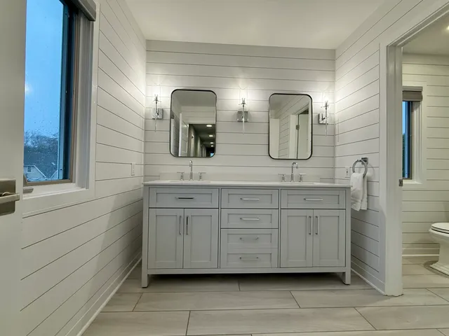 a bathroom with a double vanity sink and mirror