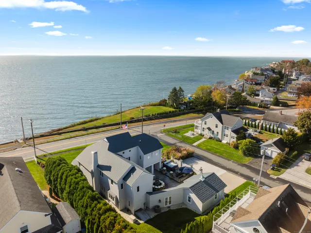 a view of a balcony with chairs and potted plants