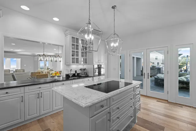 a kitchen with center island a sink appliances and cabinets
