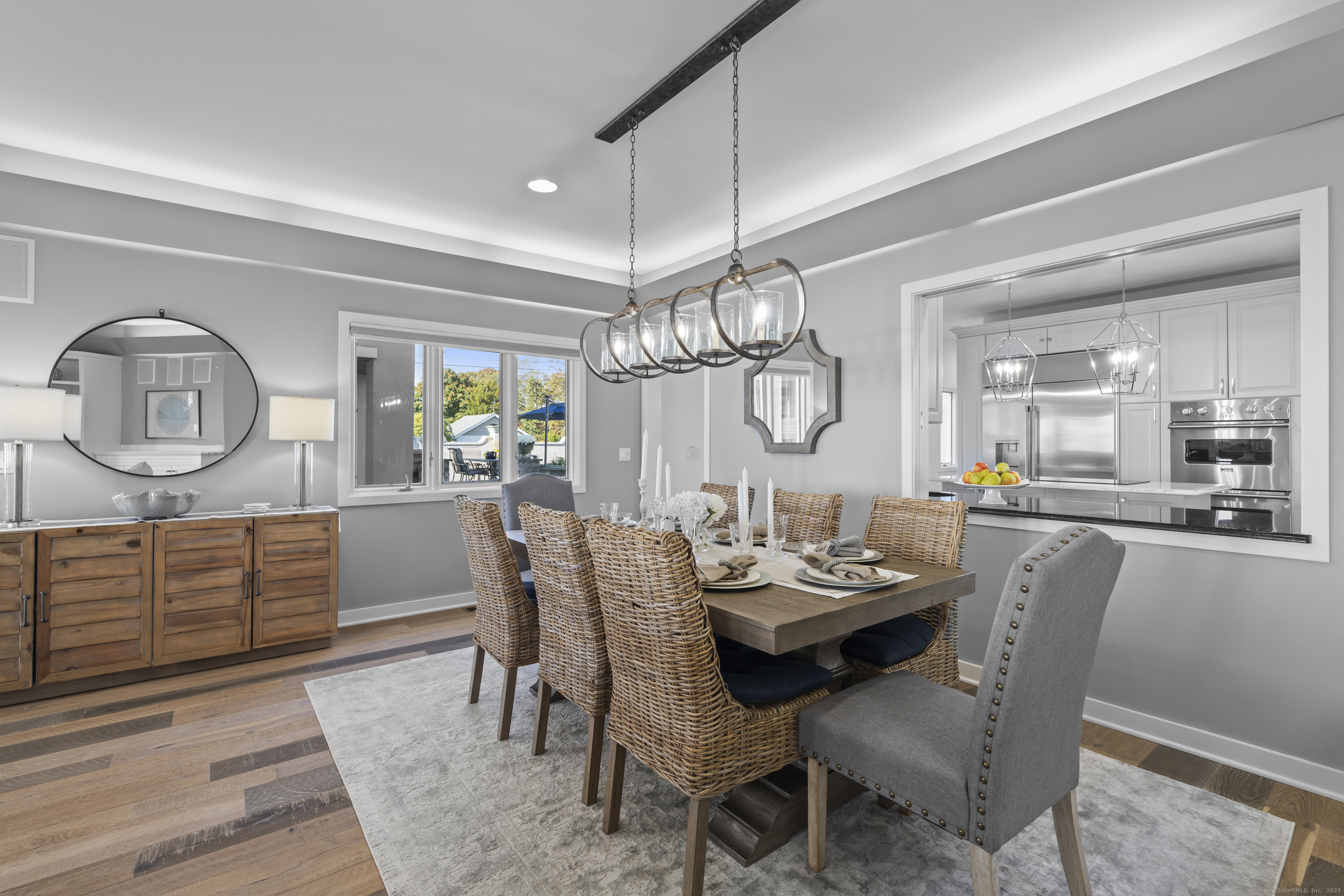 372 Maple Avenue Old Saybrook, CT 06475 - Photo 10 of 40 a view of a dining room with furniture a chandelier and wooden floor