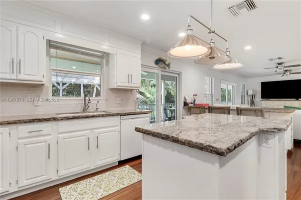 a kitchen with a sink cabinets and window