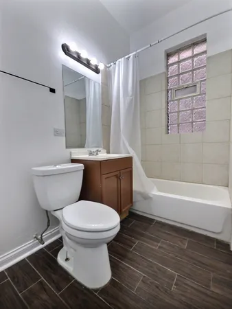 a bathroom with a toilet and a bathtub