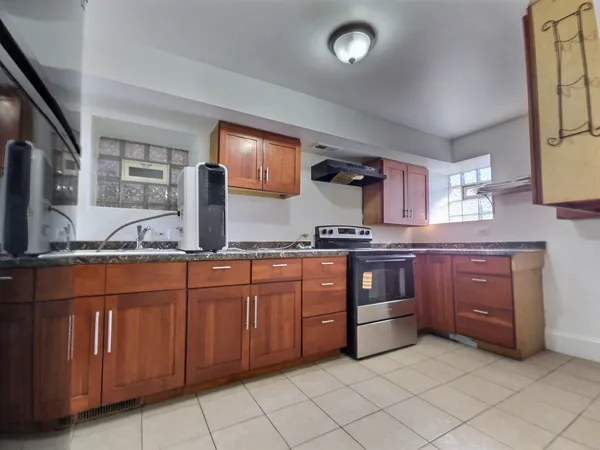 a kitchen with stainless steel appliances granite countertop a sink and cabinets