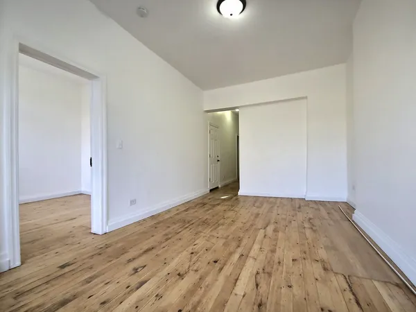 a view of a room with wooden floor