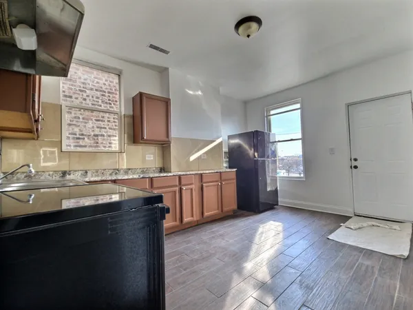 a kitchen with sink cabinets and window