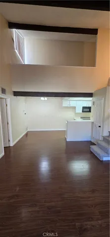 a view of a room with wooden floor