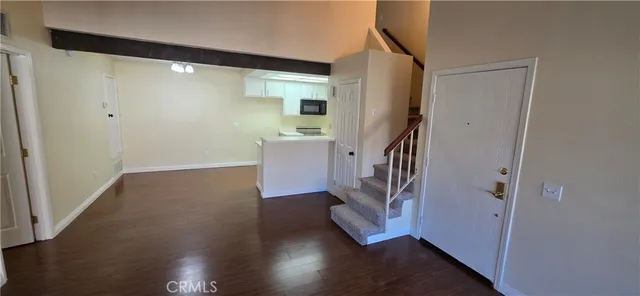 a view of entryway with wooden floor and stairs