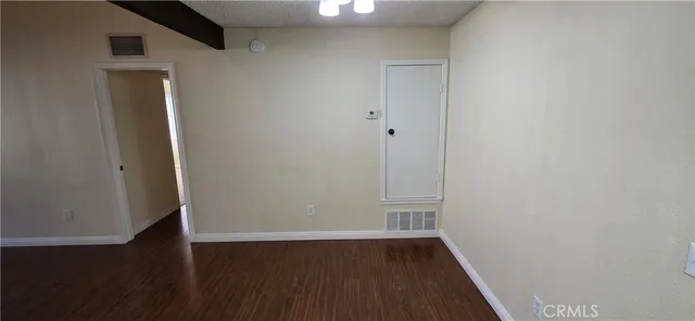 an empty room with wooden floor