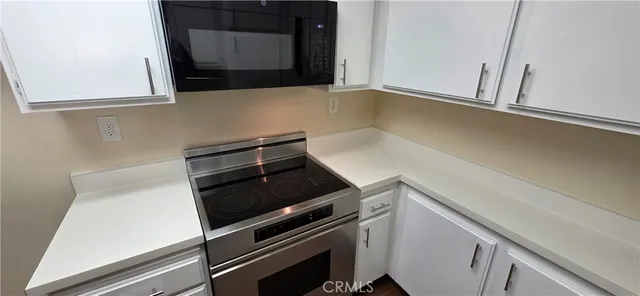 a kitchen with a stove and a microwave