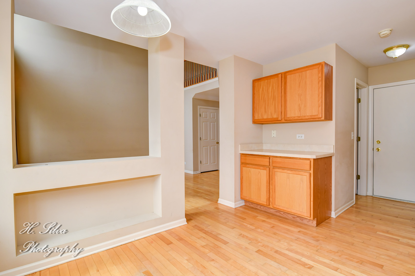 9425 Rainsford Drive Huntley, IL 60142 - Photo 5 of 15 a view of a hallway with wooden floor and cabinet