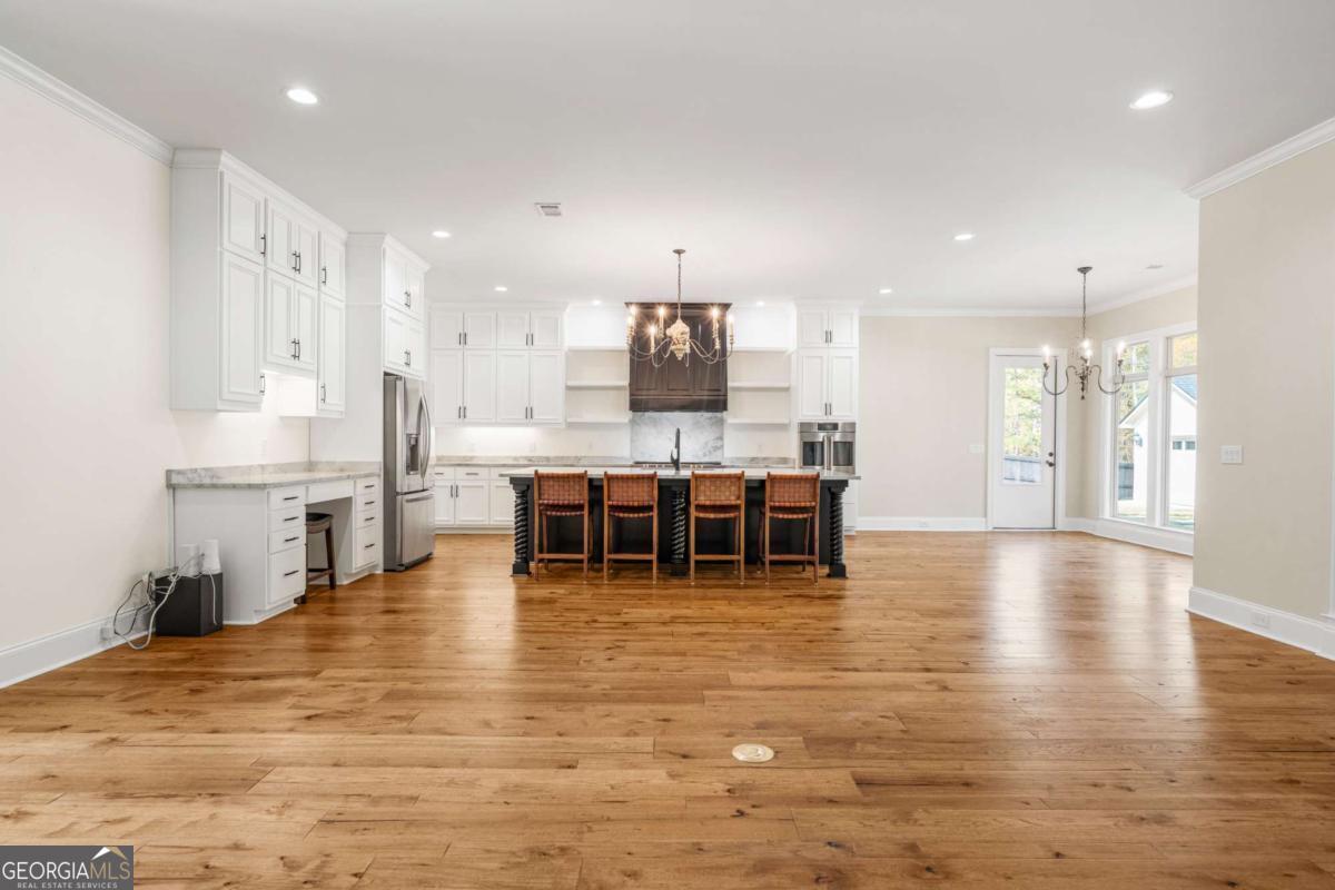 8904 Lilly Rock Way Midland, GA 31820 - Photo 5 of 49 a large swimming pool with a large window and chairs