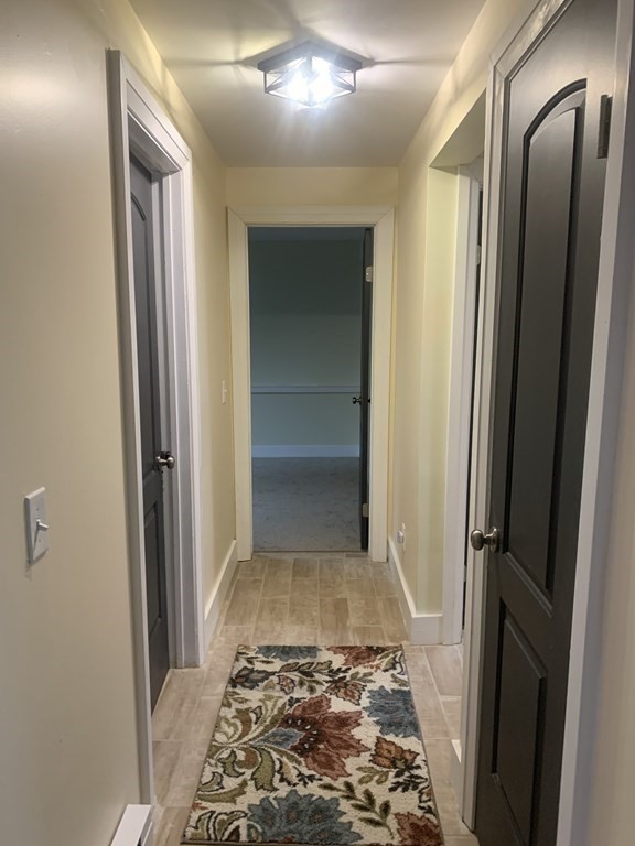 111 Warrenton Street Springfield, MA 01109 - Photo 11 of 18 a view of a hallway with wooden floor and a bathroom