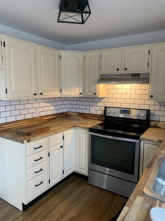111 Warrenton Street Springfield, MA 01109 - Photo 5 of 18 a kitchen with granite countertop a stove a sink and a microwave
