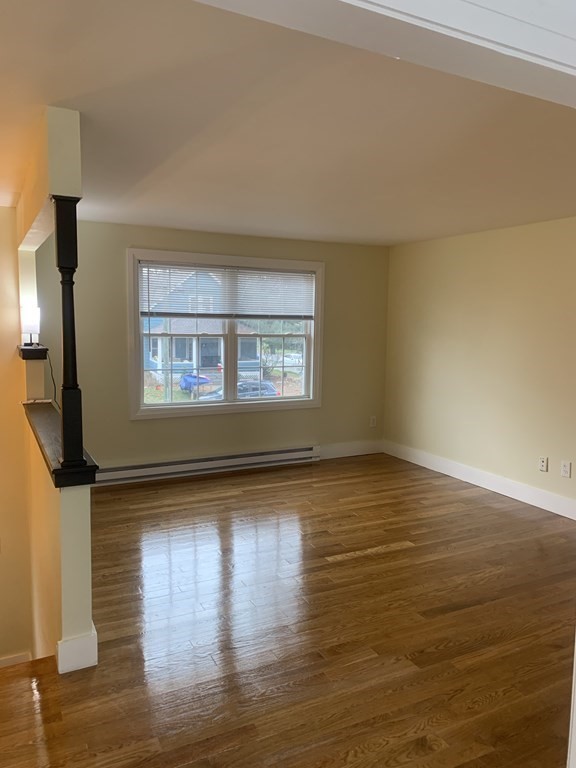 111 Warrenton Street Springfield, MA 01109 - Photo 6 of 18 a view of empty room with wooden floor and fan