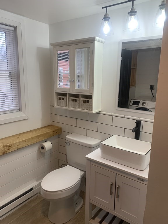 111 Warrenton Street Springfield, MA 01109 - Photo 9 of 18 a bathroom with a toilet sink and mirror