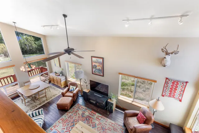 a living room with furniture a flat screen tv and a window