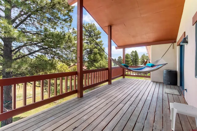 a view of balcony with wooden floor and outdoor seating