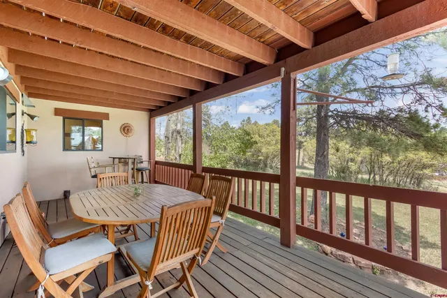 a dining room with furniture window and wooden floor