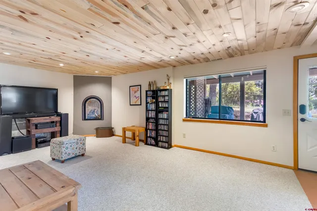 a view of a livingroom with furniture and a flat screen tv