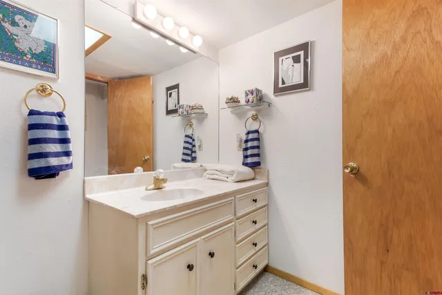 a bathroom with a sink a vanity and a mirror