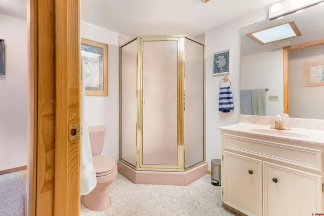 a bathroom with a shower sink and toilet