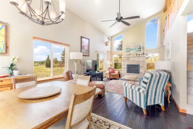 a living room with furniture a fireplace and a chandelier