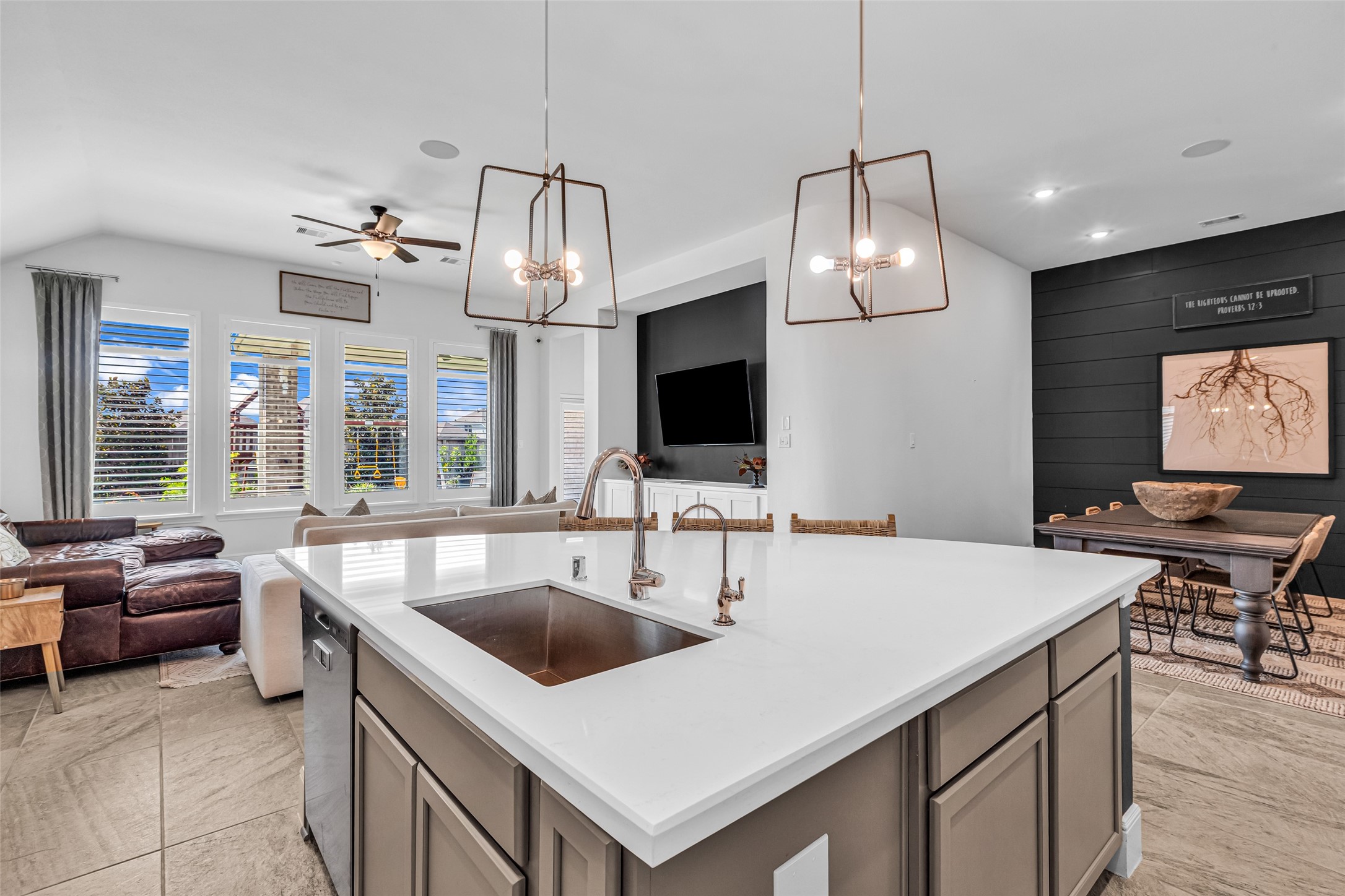 423 Bartlett Street Webster, TX 77598 - Photo 13 of 26 a kitchen with a stove a sink and a flat screen tv