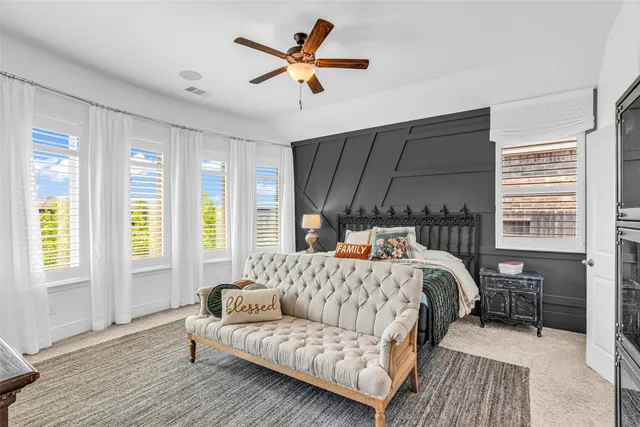 a bedroom with a bed couch and a window