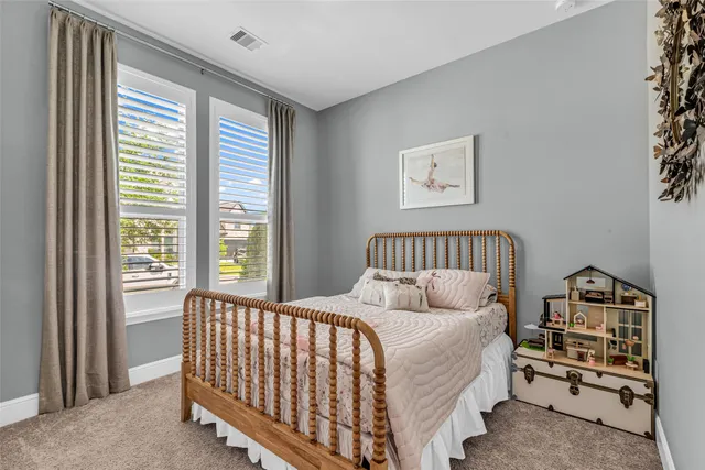 a bed sitting in a bedroom next to a window