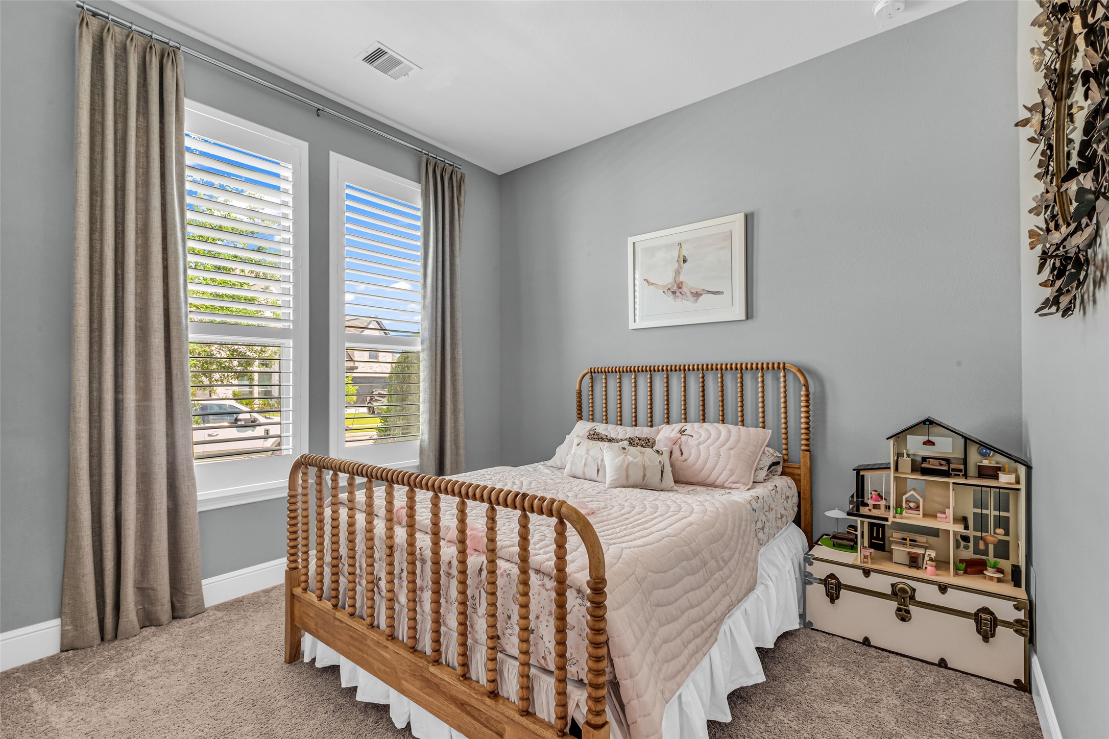 423 Bartlett Street Webster, TX 77598 - Photo 18 of 26 a bed sitting in a bedroom next to a window