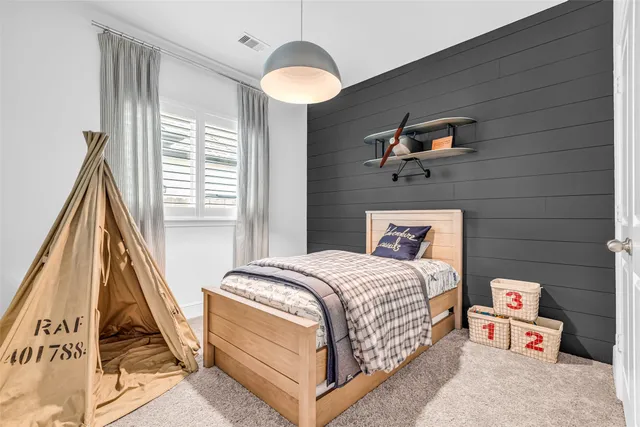 a bedroom with a bed and a large window