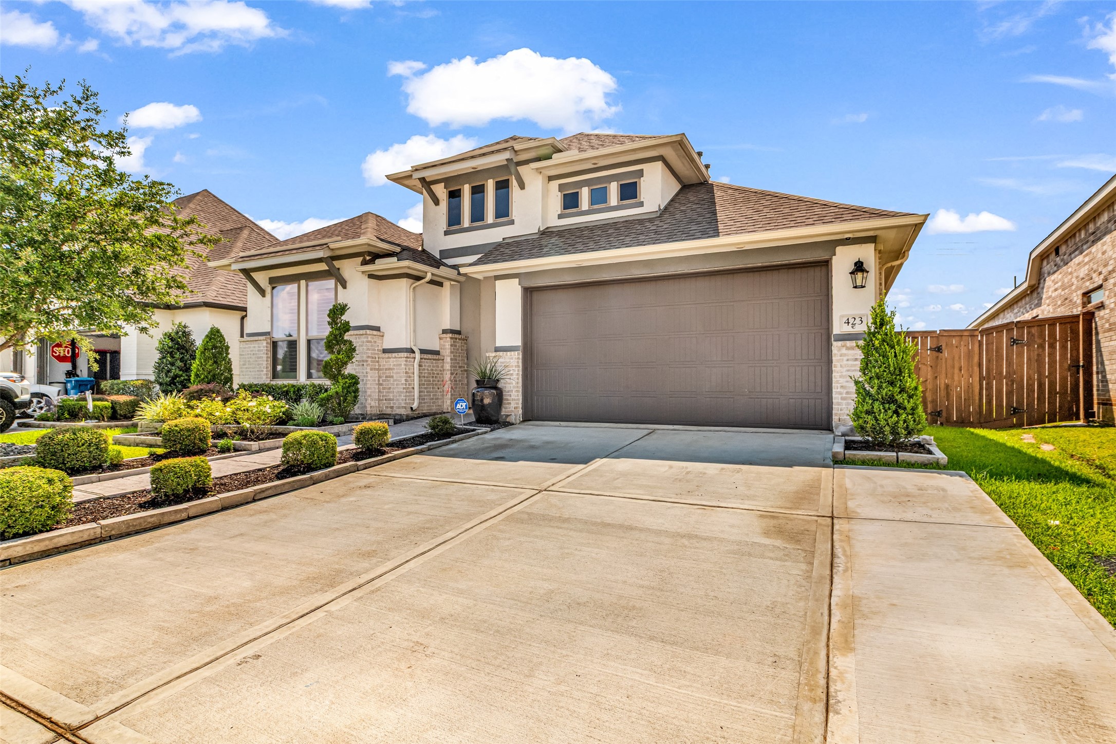 423 Bartlett Street Webster, TX 77598 - Photo 2 of 26 a front view of a house with a yard and garage
