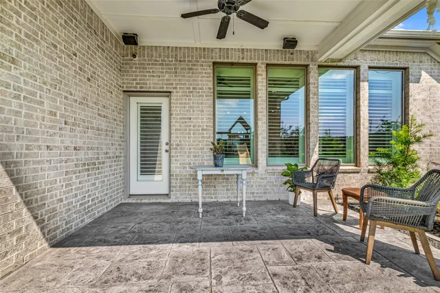 a balcony with furniture and a potted plant