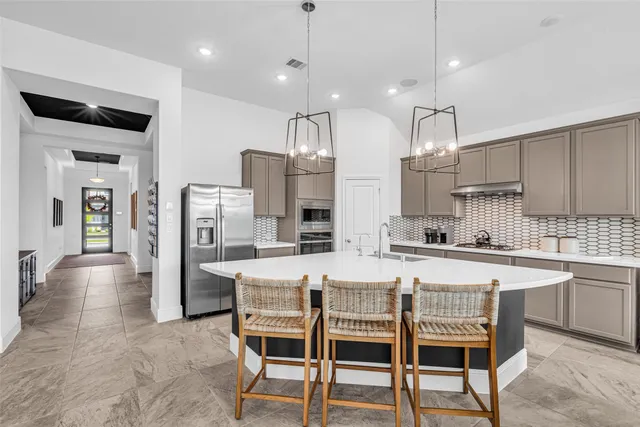 a large kitchen with a table and chairs