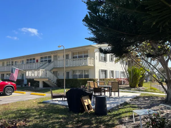 a view of a house with backyard porch and sitting area
