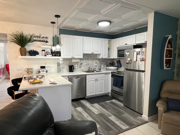 a kitchen with a refrigerator sink and cabinets
