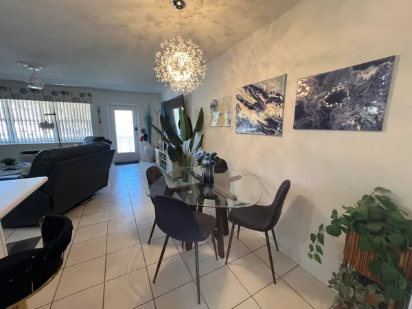 a view of a dining room with furniture and a chandelier