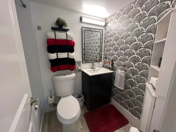 a bathroom with a toilet and a shower curtain