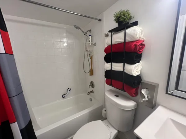 a bathroom with a toilet a bath tub and a shower