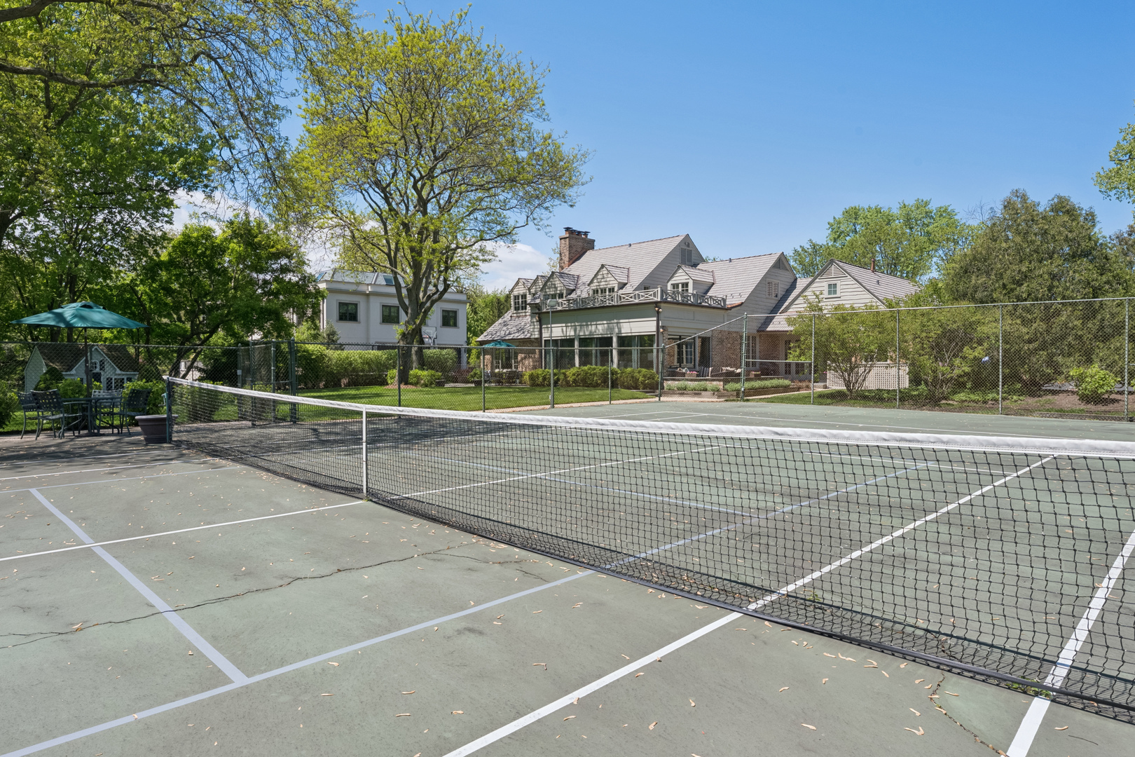 936 Sunset Road Winnetka, IL 60093 - Photo 44 of 50 a view of a tennis ground with large trees