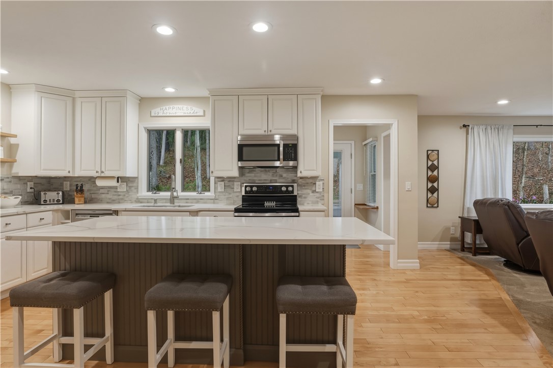 2304 Whiskey Creek Road Corning, NY 14830 - Photo 10 of 42 The breakfast bar at the kitchen island isa great place to gather, whether for meals, home work, or just catching up at the end of a busy day.