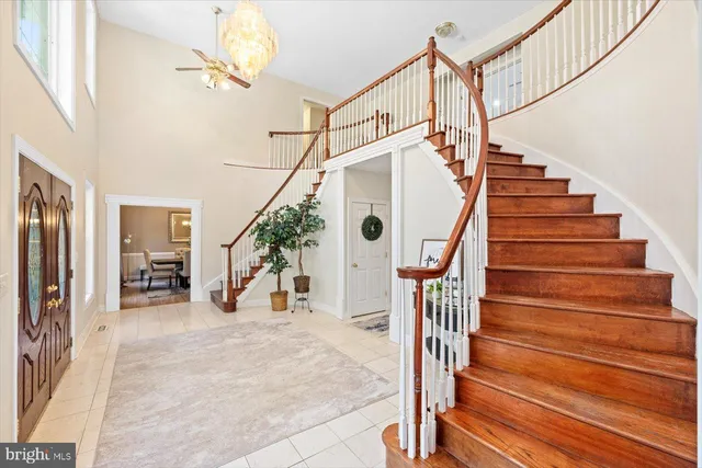 a view of a dining room with furniture a chandelier and wooden floor