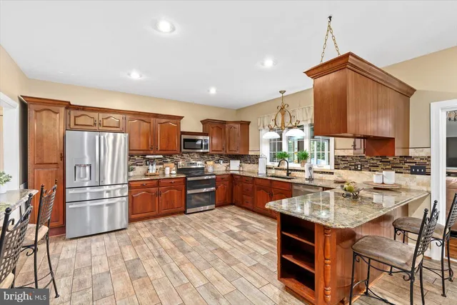 a bedroom with a bed and furniture with a flat tv screen