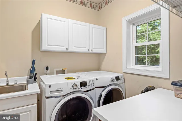 a view of a patio with couches table and chairs under an umbrella