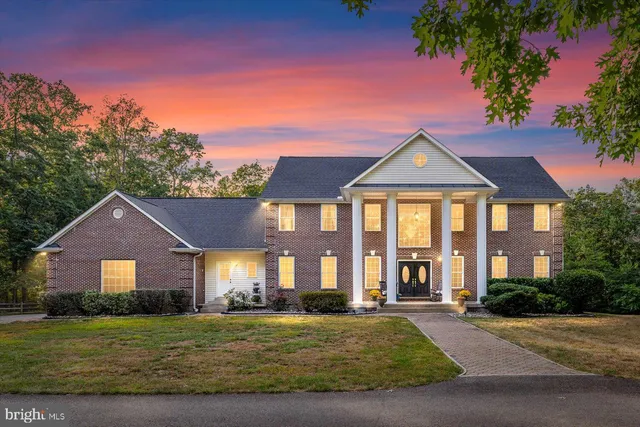 a view of staircase with lots of frames and a rug