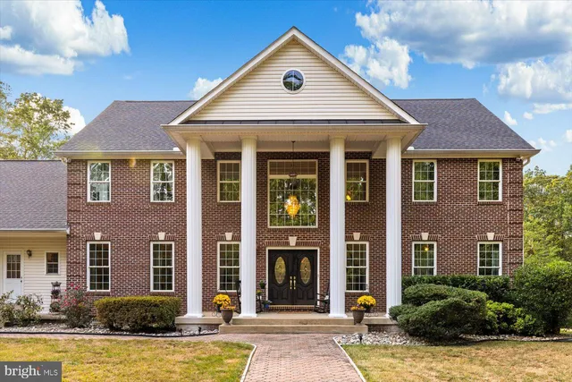 a living room with furniture a fireplace and a large window with garden view